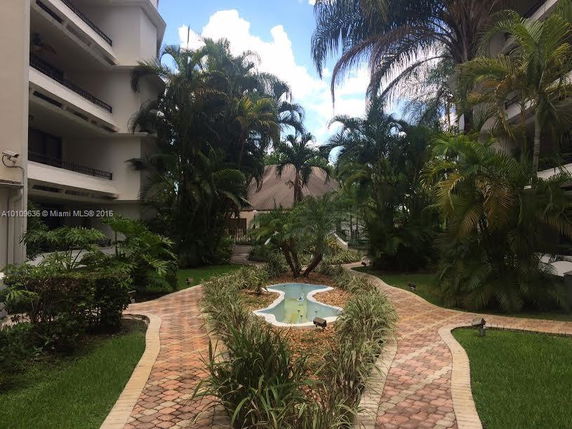 View of a landscaped garden area between two buildings.