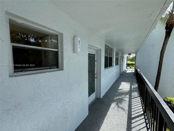 Exterior walkway of a building with windows and doors.