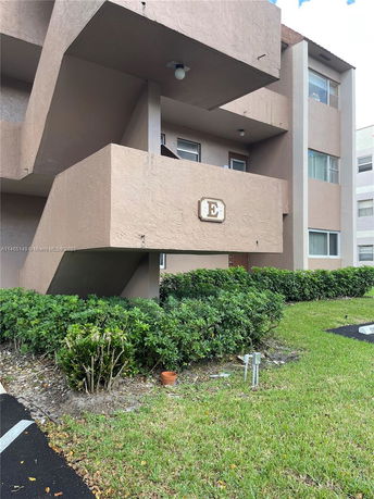 Exterior view of a multi-story residential building with balconies.