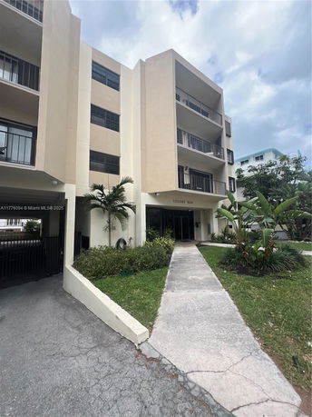 Front view of a multi-story apartment building with balconies.
