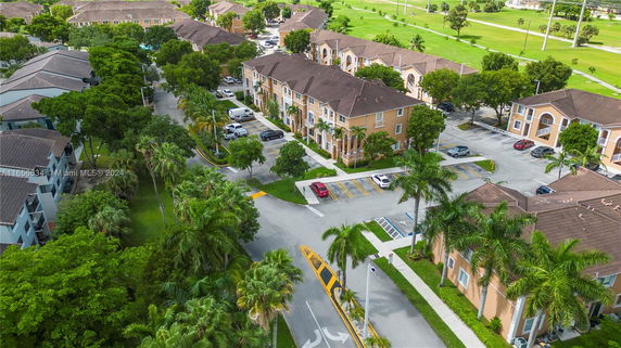 Aerial view of a residential area with multiple apartment buildings and surrounding greenery.