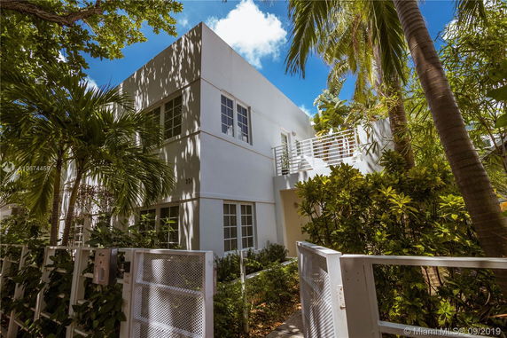 Front view of a modern two-story house with white exterior walls.
