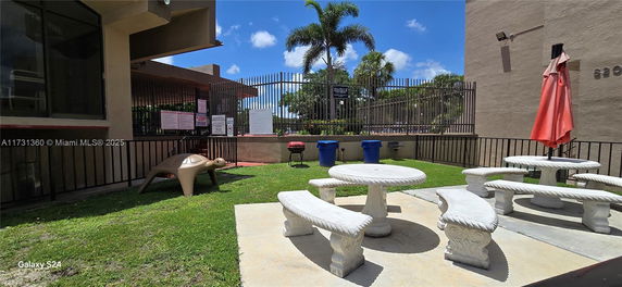 Outdoor area with stone benches and turtle play structure.