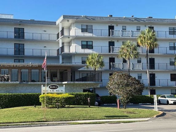 Front view of a multi-story residential building with balconies.
