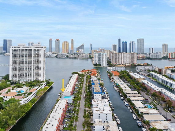 Panoramic view of a cityscape with high-rise buildings and waterways.