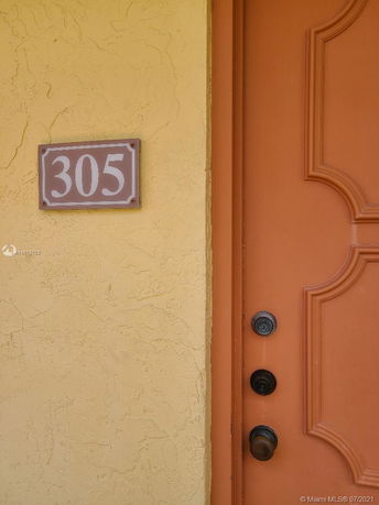 Exterior view of a door with a house number 305.