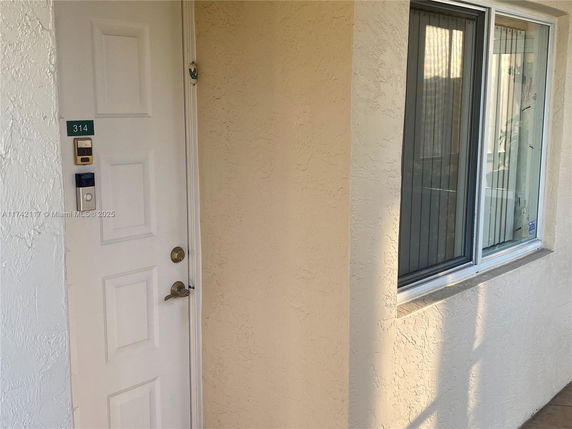 Front view of a residential unit entry door and window.