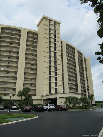 Front view of a multi-story residential building with balconies.