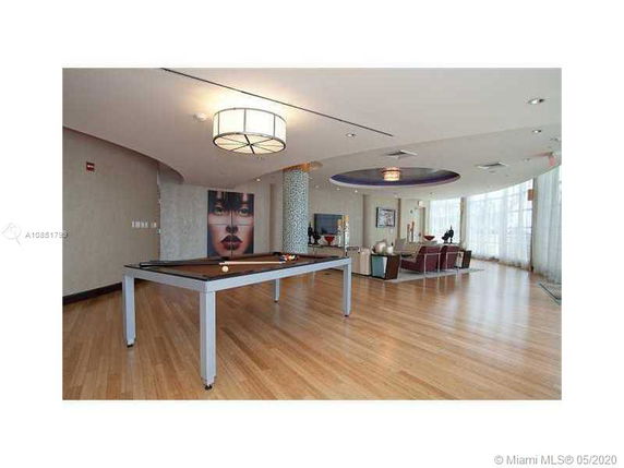 Recreational area with a billiards table and seating.