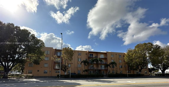 Front view of a multi-story residential building with balconies.