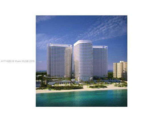 Front view of a high-rise building complex with three cylindrical towers near the waterfront.