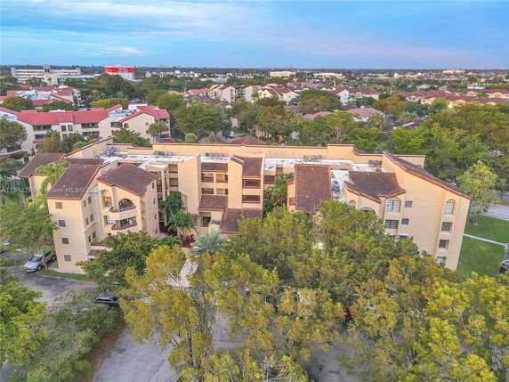 Front view of a multi-story apartment building with a tiled roof.