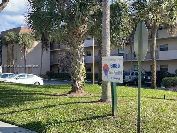 Front view of a multi-story apartment building with balconies.