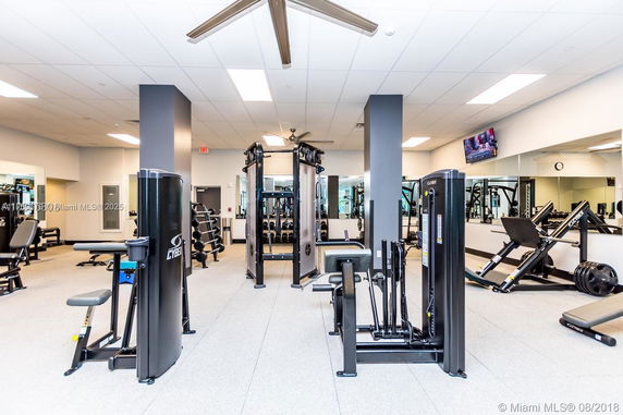 Interior view of a gym with various exercise machines and equipment.