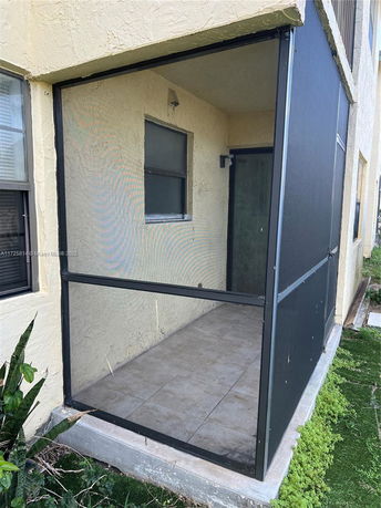 Outdoor view of a building with a screened-in porch area.