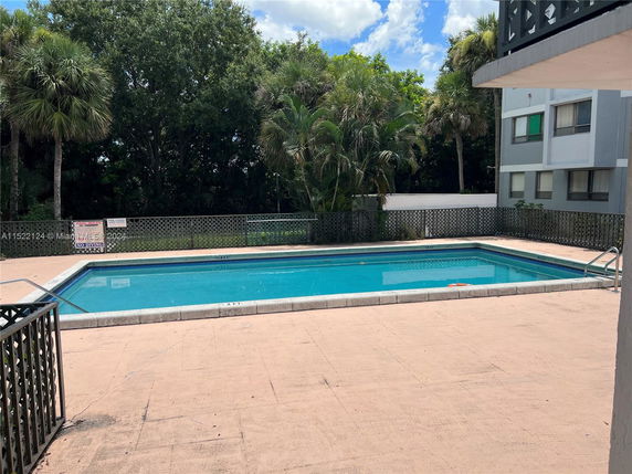 Outdoor swimming pool area adjacent to a building.