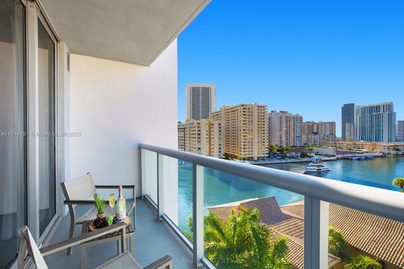 Panoramic view from a balcony showing buildings and a waterway.