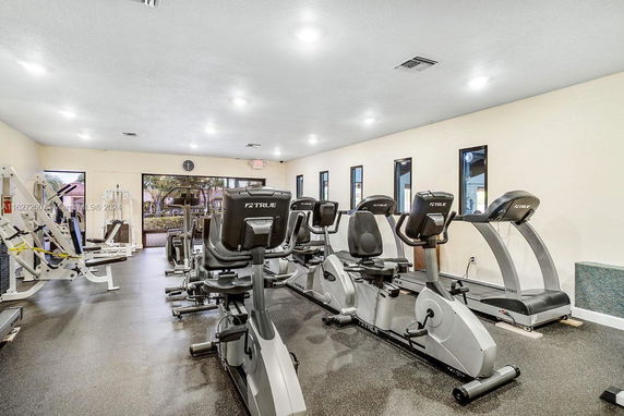 Gym area with exercise machines and cardio equipment.