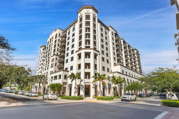 Front view of a multi-story residential building with balconies.