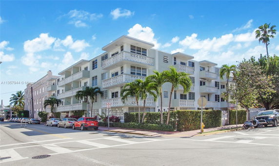 Front view of a multi-story apartment building with balconies.