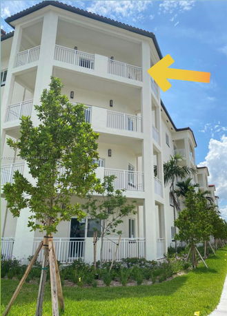 Front view of a multi-story building with balconies