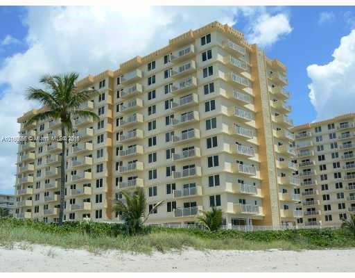 Front view of a multi-story beachfront condominium building.