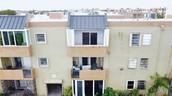 Front view of a multi-story residential building with balconies.
