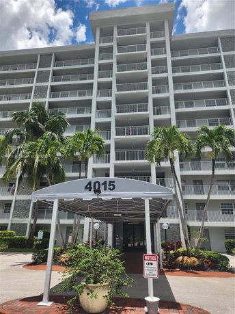 Front view of a multi-story residential building with balconies.