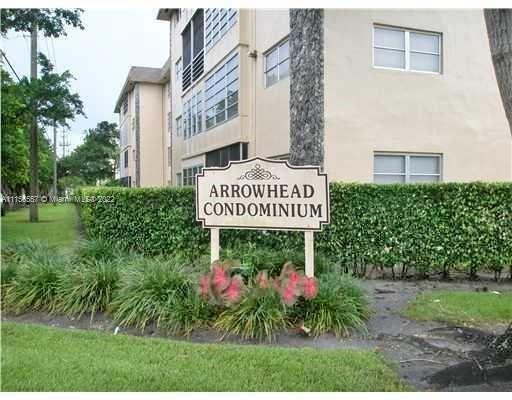 Front view of a condominium building labeled Arrowhead Condominium.