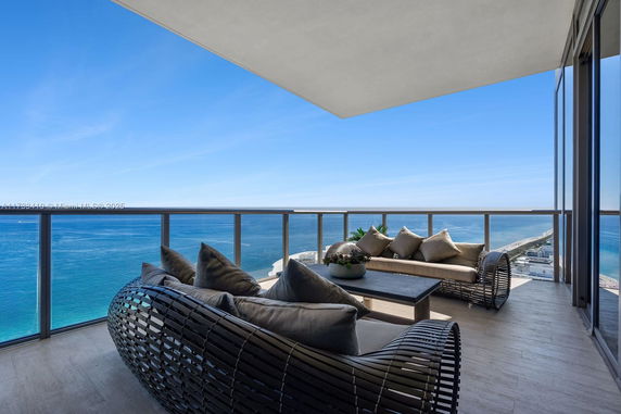 Balcony with outdoor seating and ocean view