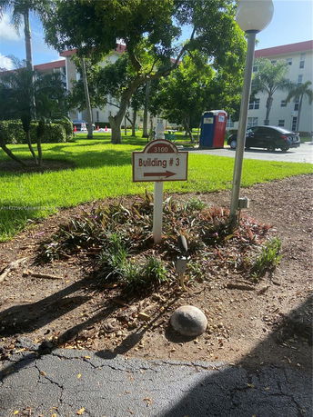 View of building and surrounding area with trees and sign indicating Building #3.