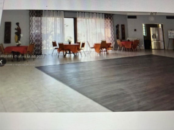Interior space with tables and chairs set up for recreation or events.