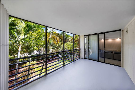 Screened porch with view of lush greenery