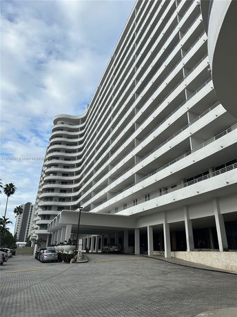 Front view of a multi-story building with curved balconies.