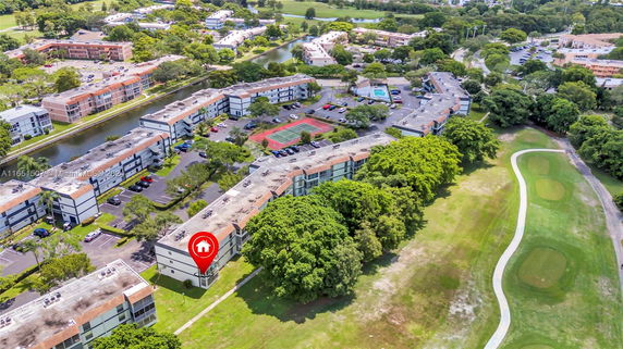Aerial view of a residential area with multiple buildings and green spaces.
