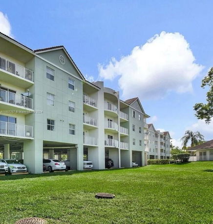 Front view of a multi-story apartment building with balconies.