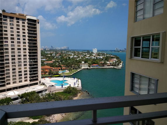 Panoramic view from a building showing other high-rise buildings, waterfront properties, and a body of water.