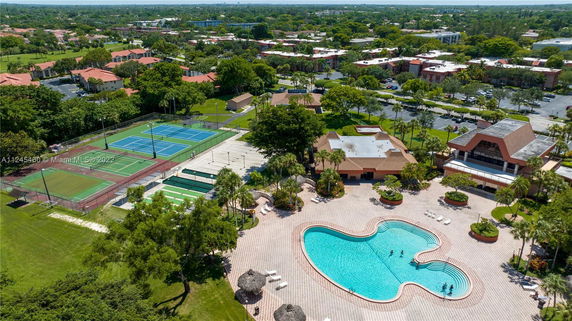 Aerial view of recreational area with tennis courts and a swimming pool.