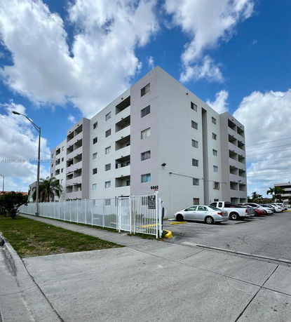 Front view of a multi-story residential building with balconies.