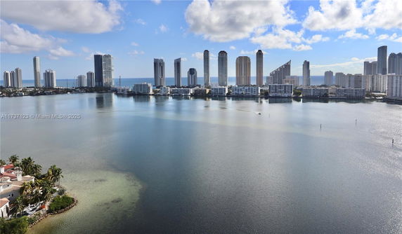 Panoramic view of a waterfront cityscape with high-rise buildings.