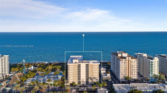 View of a coastal high-rise building with the ocean in the background.