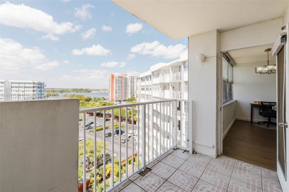 Balcony view overlooking surrounding buildings and a body of water.