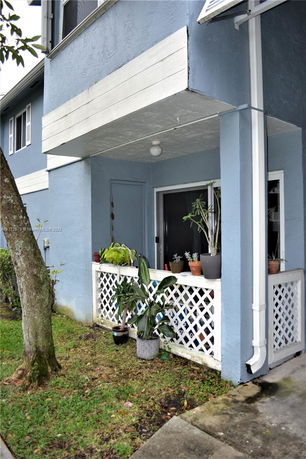 Front view of a two-story building with a small porch area.