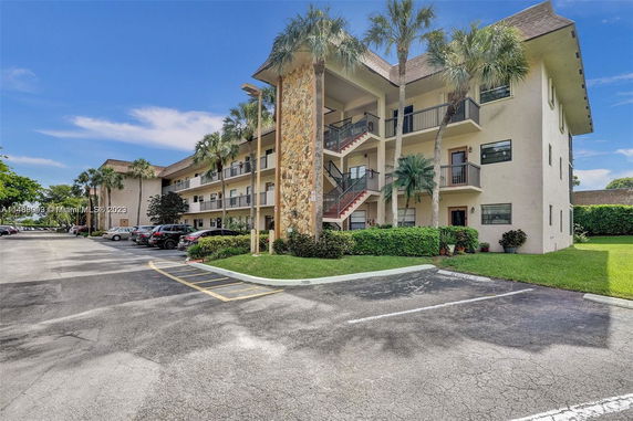 Front view of a multi-story apartment building with exterior staircases.