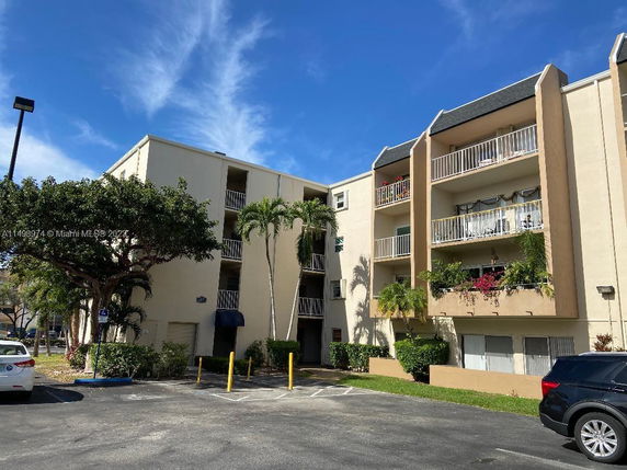 Front view of a multi-story residential building with balconies.
