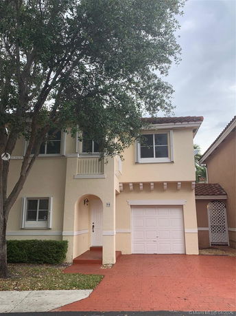 Front view of a two-story house with a garage.