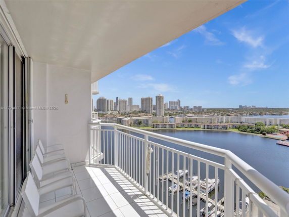 Balcony view overlooking a body of water and cityscape.