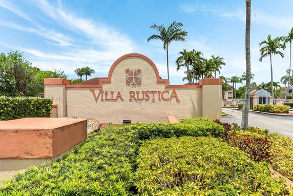 Front view of Villa Rustica entrance sign with landscaping.