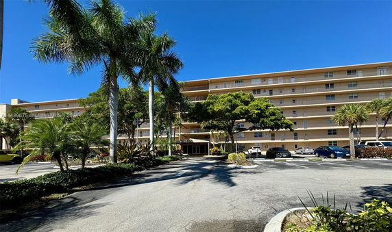 Front view of a multi-story residential building with balconies.