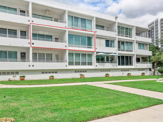 Front view of a multi-story apartment building with balconies.